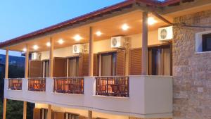 a building with balconies with lights on it at House Chrysoula Mitsokopi in Sarti