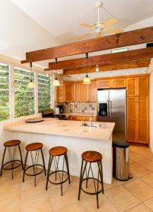 a kitchen with a large island with bar stools at Las Terrazas Los Chivos in Vieques