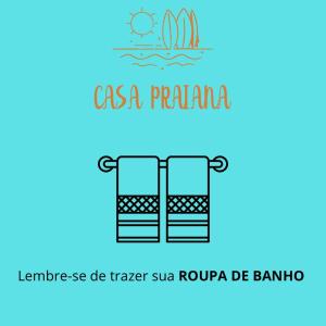 um logotipo para uma empresa de turismo com um barco na água em Casa Praiana no Guarujá