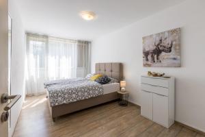 Posteľ alebo postele v izbe v ubytovaní Sunny City Apartment
