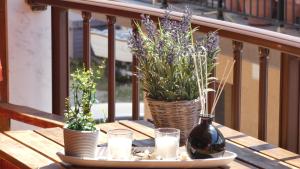 a wooden table with two vases with flowers and candles at House Chrysoula Mitsokopi in Sarti