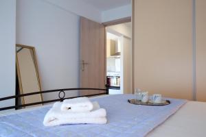 A bed or beds in a room at Ionian White - Apartment C