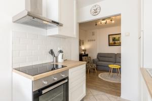 a kitchen with a sink and a stove top oven at Sunny City Apartment in Split