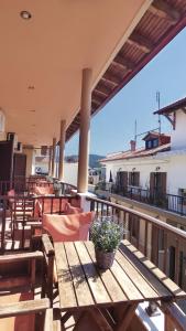 a patio with a wooden table and chairs on a balcony at House Chrysoula Mitsokopi in Sarti
