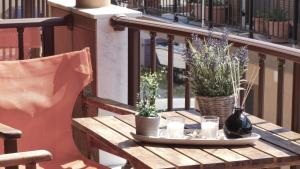 a wooden table with candles and flowers on a balcony at House Chrysoula Mitsokopi in Sarti