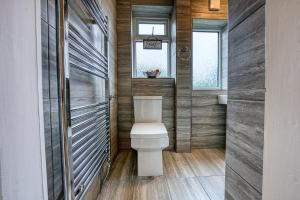 a bathroom with a toilet and a sink at Modern 3 Bedroom 2 Bath House with Parking by 360Midlands Wednesbury, Birmingham in Birmingham +26 photos