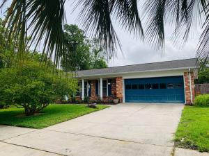 a brick house with a blue garage at Cush Jax Baymeadows Ranch, Close to Everything! in Jacksonville