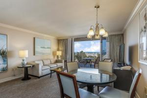 a living room with a dining room table and a couch at Marco Beach Ocean Resort IV in Marco Island