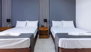 Ένα ή περισσότερα κρεβάτια σε δωμάτιο στο Hotel Taurus