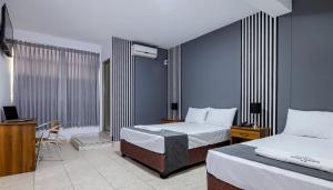 Ένα ή περισσότερα κρεβάτια σε δωμάτιο στο Hotel Taurus