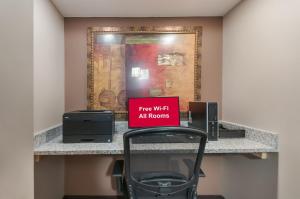 a sign sitting on a desk in a hotel room at Red Roof Inn Dahlgren - Naval Base in Dahlgren