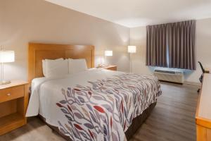 a hotel room with a large bed and a window at Red Roof Inn Dahlgren - Naval Base in Dahlgren
