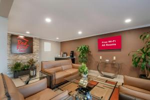 a waiting room with furniture and a sign that reads fear what awaits at Red Roof Inn Dahlgren - Naval Base in Dahlgren