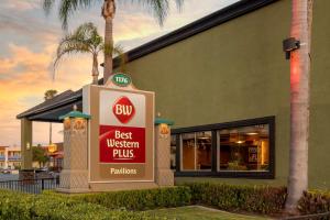 a best western plus sign in front of a building at Best Western Plus Pavilions in Anaheim