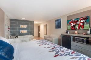 a hotel room with a large bed and a bathroom at Red Roof Inn Dahlgren - Naval Base in Dahlgren