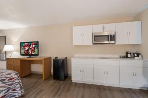 a kitchen with white cabinets and a microwave at Red Roof Inn Dahlgren - Naval Base in Dahlgren