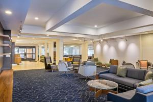 a waiting room with couches and chairs and tables at Sonesta Select San Ramon in San Ramon