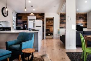 a kitchen and living room with blue chairs at Table Hill Cottage in Daylesford