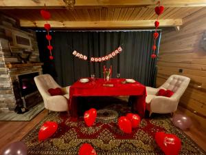 a table with red hearts and a sign that reads happy appreciation at Riona dağ evleri in Çamlıhemşin +107 photos