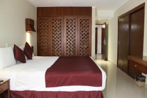 Postel nebo postele na pokoji v ubytování Hotel Plaza Kokai Cancún