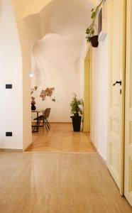 an empty hallway with a table and a door at The Industrique Home - 3 Bedroom Apartment in Timişoara
