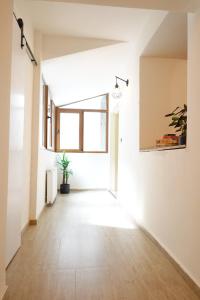 an empty hallway with a large window in a building at The Industrique Home - 3 Bedroom Apartment in Timişoara