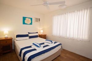 A bed or beds in a room at Apollo Jewel Beachfront Apartments