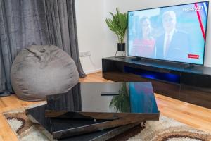 a living room with a tv and a coffee table at Vanville Homes in Manchester