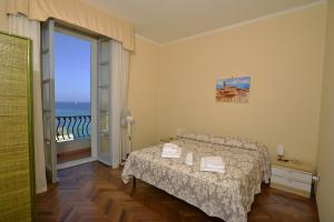 a bedroom with a bed and a view of the ocean at Casa Alice in Alghero