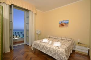 a bedroom with a bed and a view of the ocean at Casa Alice in Alghero