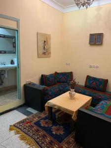 a living room with two couches and a table at Dar el Koutoubia in Marrakesh