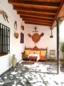 a living room with a couch and a table at Casa Rural El Rincon del Infante in Villa de Don Fadrique