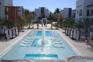 a fountain in the middle of a swimming pool at Espectacular Apartamento En Tanama Cap Cana in Punta Cana