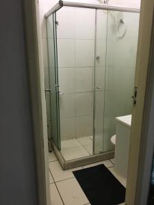 a shower with a glass door in a bathroom at Meu Apartamento a 15min de Copacabana in Rio de Janeiro +22 photos