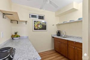 a kitchen with a sink and a counter top at The Sanctuary in Captain Cook