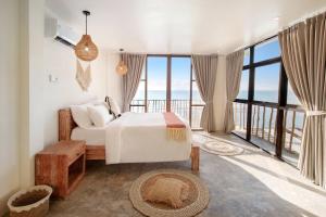 a bedroom with a bed and a view of the ocean at Impossible Cliff House in Uluwatu