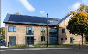a large brick building with solar panels on it at City Centre yet quiet -- Modern 2bed home with wine -- Parking 1 min walk in York