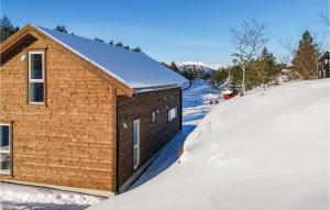 a small brick house in the snow at Beautiful Home In Skare With 3 Bedrooms in Lii
