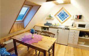 a kitchen with a wooden table with a vase on it at Lovely Home In Lrbro With House Sea View in Slite