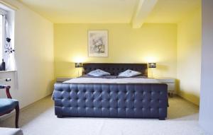 ein Schlafzimmer mit einem blauen Bett in einem gelben Zimmer in der Unterkunft Amazing Apartment In Bad Berleburg-berghs, With 2 Bedrooms And Wifi in Bad Berleburg