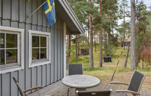 a patio with a table and chairs and a flag at 2 Bedroom Stunning Home In Yngsj in Yngsjö