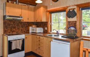 a kitchen with a sink and a stove top oven at 2 Bedroom Stunning Home In Yngsj in Yngsjö
