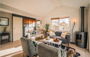 a living room with a couch and a fireplace at Stunning Home In Tzummarum With Wifi in Tzummarum