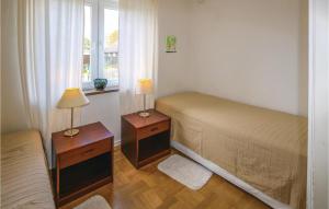 a bedroom with two beds and two lamps on tables at 3 Bedroom Lovely Home In Bunkeflostrand in Bunkeflostrand