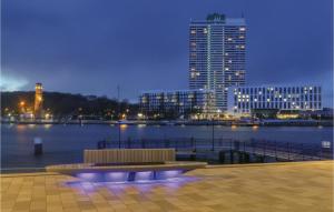 a bench sitting next to a body of water with buildings at Highend Travemünde - Whg 410 in Travemünde +30 photos