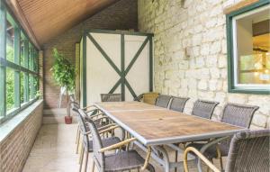 a wooden table and chairs on a patio at Vakantiewoning 4 in Simpelveld