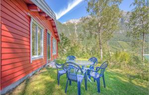 a table and chairs on the side of a house at Awesome Home In Olden With 3 Bedrooms, Sauna And Wifi in Olden