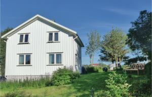 a white house on a grassy field with a tree at Beautiful Home In Vega With Wifi in Holand