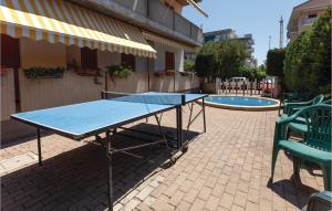 a ping pong table in front of a pool at Bilo Sup in Alba Adriatica