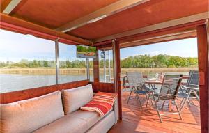 a living room with a couch and a tv on a boat at Hafen Loitz in Loitz